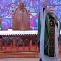 Woman violently pushes Priest off stage during mass live broadcast.