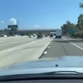 Lady on drugs driving car without a wheel on a freeway