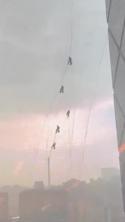 Strong storms sent window workers dangling wildly from the China ...