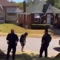 Two cops chasing a crazy person in the street.