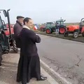 A Priest blessing the farmers going toward Paris