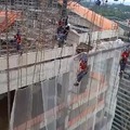Workers hanging on cables in Brazil