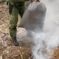 Initiating a fire in a rocket stove on the ground